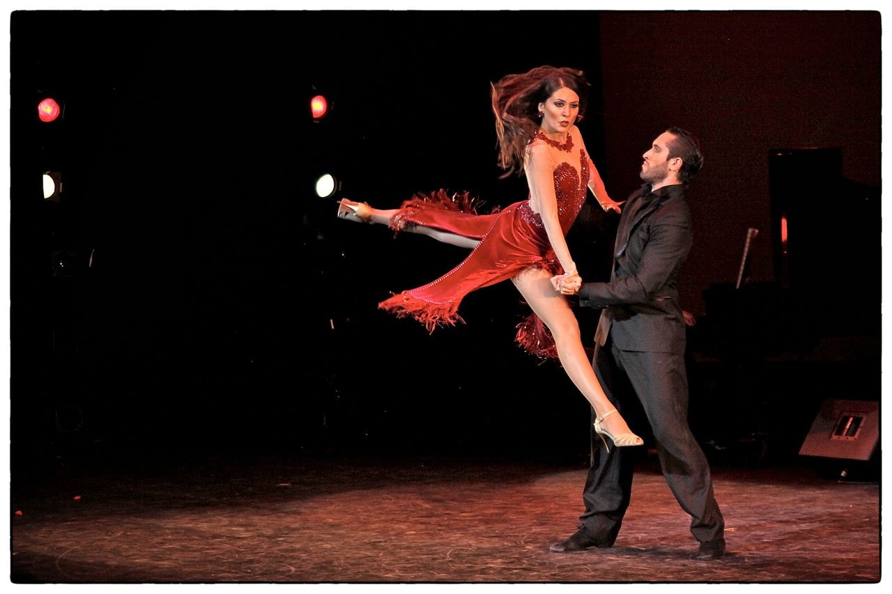 Tango Lovers dramatic dance lift in red dress